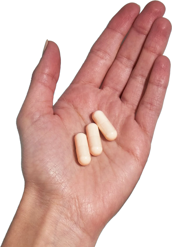 image of hand holding 3 Performance Lab® EU Magnesium capsules
