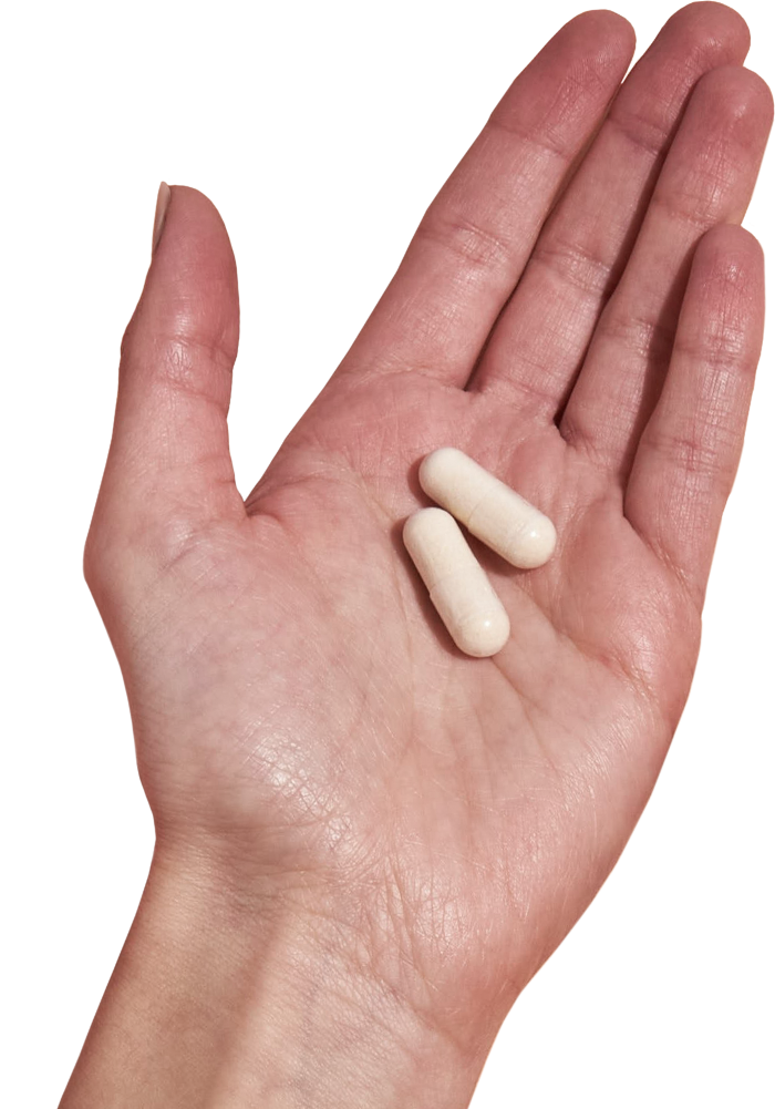 image of hand holding 2 Performance Lab® EU Magnesium capsules
